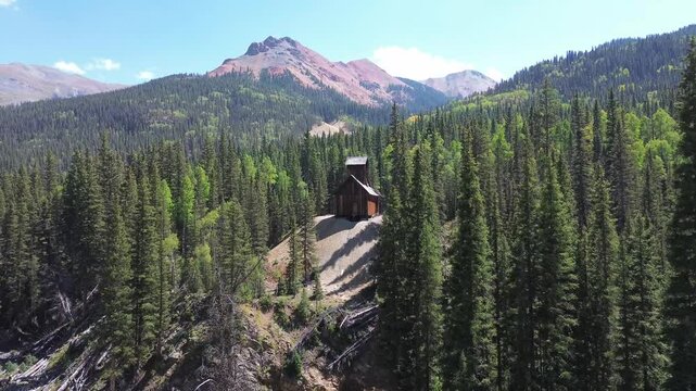Colorado Boy Mine near the Engineer Pass in Colorado. Wide angle shot flies towards the mine, across a small valley. Red Mountain appears in the background.