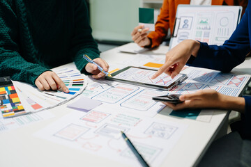  UX developer and ui designer brainstorming about mobile app interface wireframe design with...