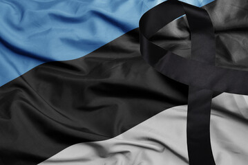 waving national flag of estonia with black mourning ribbon .tragedy concept