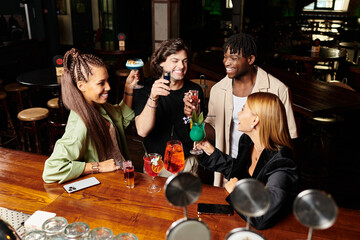 Colleagues enjoy a vibrant corporate party, raising drinks in celebration and friendship.