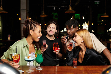 A lively gathering where young professionals celebrate, sharing drinks and laughter.