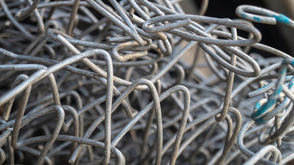 A large pile of tin wire close-up. Close-up of tin wire lying outdoor