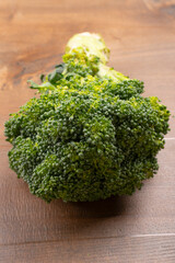 Raw fresh broccoli on old wooden table.