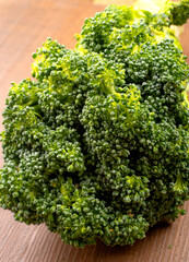 Raw fresh broccoli on old wooden table.