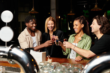 Young professionals enjoy a cheerful toast together at a corporate party, celebrating success.