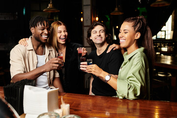 Young professionals celebrate together, raising glasses at a corporate event.