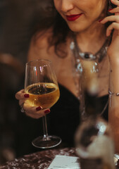person with a glass of white wine
