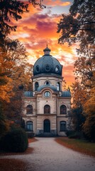 Historic Building with Dome and Stone Pathway Under a Vibrant Sunset Sky.
