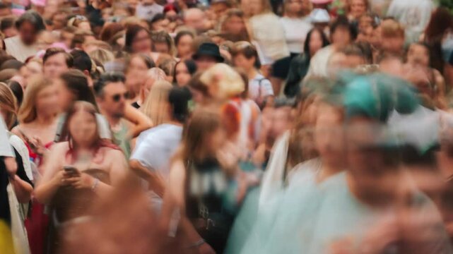 Close-up time-lapse unrecognizable blurry huge crowd of people crossing city street, busy crossroad fast motion, many pedestrians walking crosswalk. Rush hour crowded, people walk, blurred faces