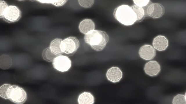 Halos de lumi&egrave;res refl&eacute;t&eacute;s sur de l'eau au ralenti