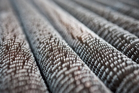 Condensing unit aluminium close up wire finned obsolete tubes grill perspective diagonal texture, compressor and air conditioning system. Industrial background metal material for industry rib heater.