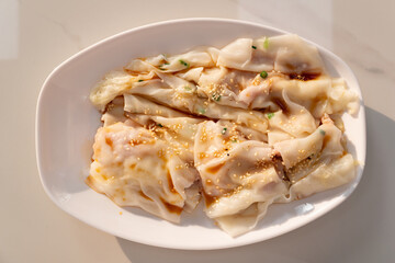 top view traditonal Cantonese food of cheong fun or rice noodle rolls or steamed vermicelli rolls horizontal composition