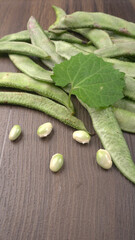 Pile of green beans over wooden background, Healthy food concept
