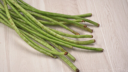 French beans with stewed green peas on wooden background. Healthy food concept.