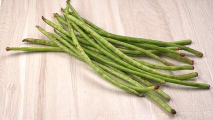 French beans with stewed green peas on wooden background. Healthy food concept.