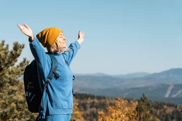 Fototapeten Female with Backpack on Hike in nature © Tatyana Gladskih
