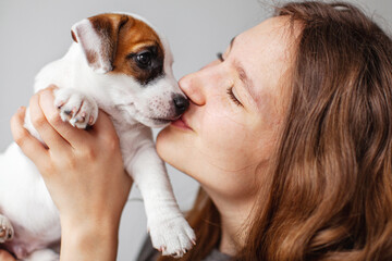 Woman Playing with cute Puppy Dog at home © Tatyana Gladskih