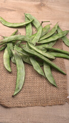 Pile of green beans over wooden background, Healthy food concept