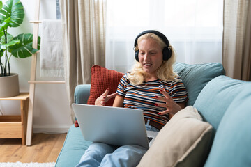 Young woman talking on video call with her psychotherapist doctor after online therapy sessions,...