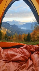 A view from inside an orange tent, looking out at the beautiful autumn mountain landscape with trees and mountains in distance