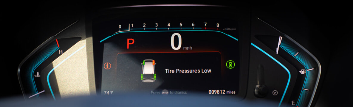 Panorama view tire pressure low indicator display on instrument panel of modern car minivan in Parking mode, tire pressure monitoring system TPMS indicates lights on driver information interface