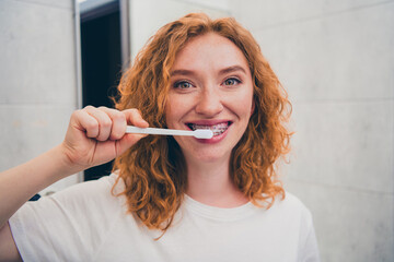 Photo of happy cute girl brushing teeth in home enjoying oral hygiene teeth cleaning fresh breath