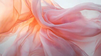 Fototapeta premium A flowing, pink and peach-colored fabric with an ethereal feel, giving the impression of movement and fluidity