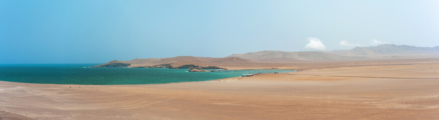 Fototapeta premium Panoramic view Paracas, Peru, A beautiful beach with a calm ocean and a small island in the distance