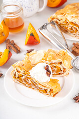 Sweet homemade pumpkin strudel. Tasty autumn pumpkin squash strudel cake with walnut and cinnamon, topped with vanilla ice cream scoop