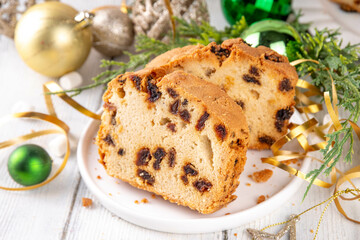Homemade Christmas dried fruit cake with raisins and cranberry, on festive holiday decorated  background