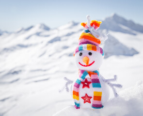Happy snowman in mountains