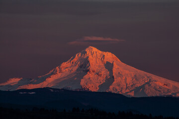 Beautiful sunset at Oregon's icon Mount Hood captured from Jonsrud Viewpoint in Sandy, OR. Golden hour sunlight showing off the snow peak. High quality picture for download.