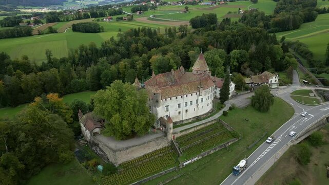 Pull back crane up drone shot of beautiful Oron Castle in Vaud Switzerland