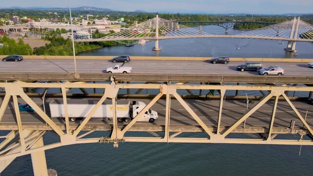 AERIAL DRONE FLYING OVER INTERSTATE 205 HIGHWAY BRIDGE. URBAN AREA