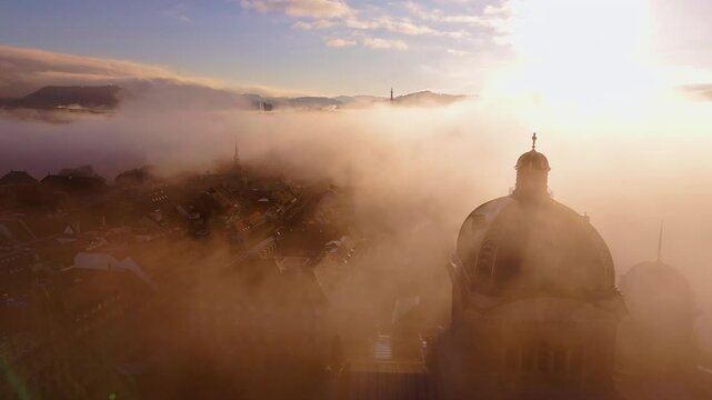 Bern capital city of Switzerland overflight during fog and sunrise