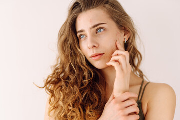 Young woman with acne and rashes on her face. Dermatology, cosmetology, skin care. Natural skin.