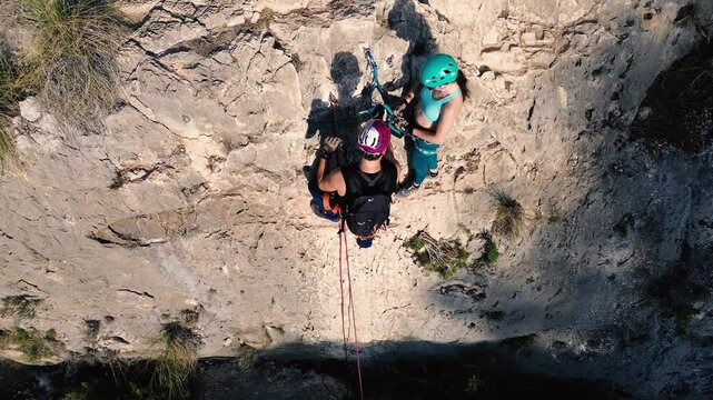 Man rock climbing aerial view of sportsman rapelling mountain in La Panocha, el Valle Murcia, Spain woman rapel down a mountain climbing a big rock