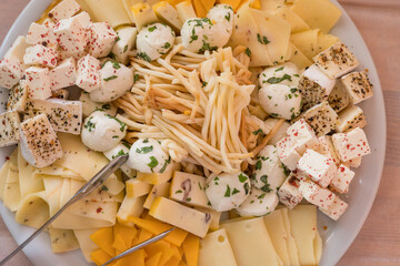 Tasty cold snacks. Bowl with salami, cheese, vegetables for a cold snack.
