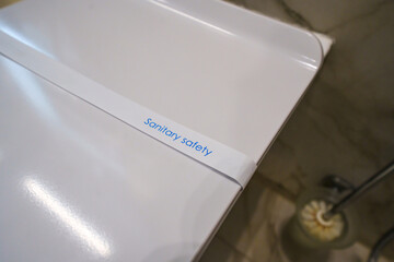 a paper strip with the inscription Sanitary safety on the toilet. 
