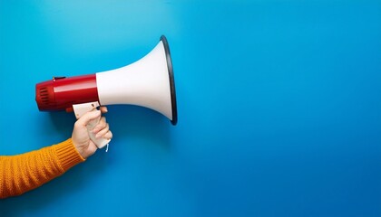 A megaphone in a hand on background