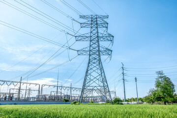High voltage electricity tower and woods and meadows