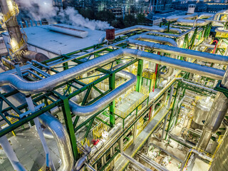 Oil refinery chemical plant industrial equipment buildings at night