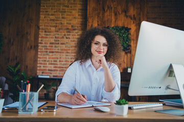 Photo of pretty curly young girl thinking working manager wear formalwear business adviser coworking successful nice light office