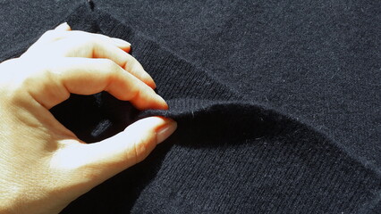 Dark blue cashmere. Cashmere sweater. Woolen fabric texture. Textile dark background.