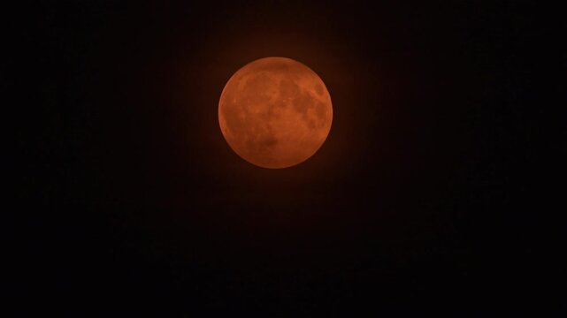 Moon supermoon in the September night sky seen from The Netherlands during a hazy evening.