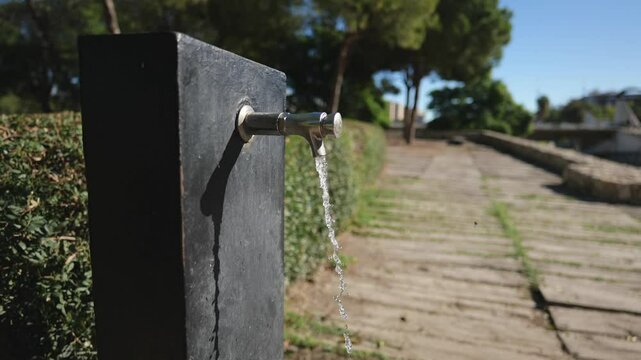 Water Flows From a Street Tap on a Sunny Day. Slow Motions. 4K