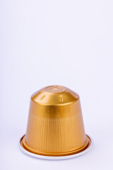 Golden Coffee Capsule on White Background