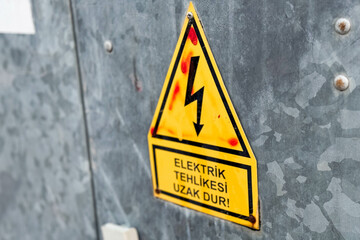 Turkey street metal electrical panel with lightning caution sign and inscription.