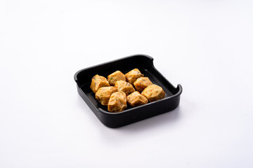 Savory Snacks in a Black Plate on White Background