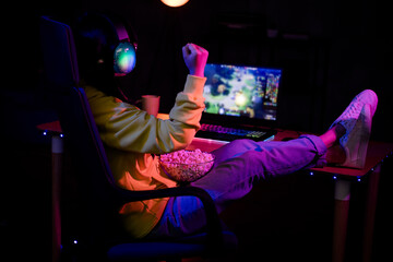 Full body photo of cute lovely nice girl winning watch stream eat pop corn play gamer computer laptop modern technology indoors late night © deagreez